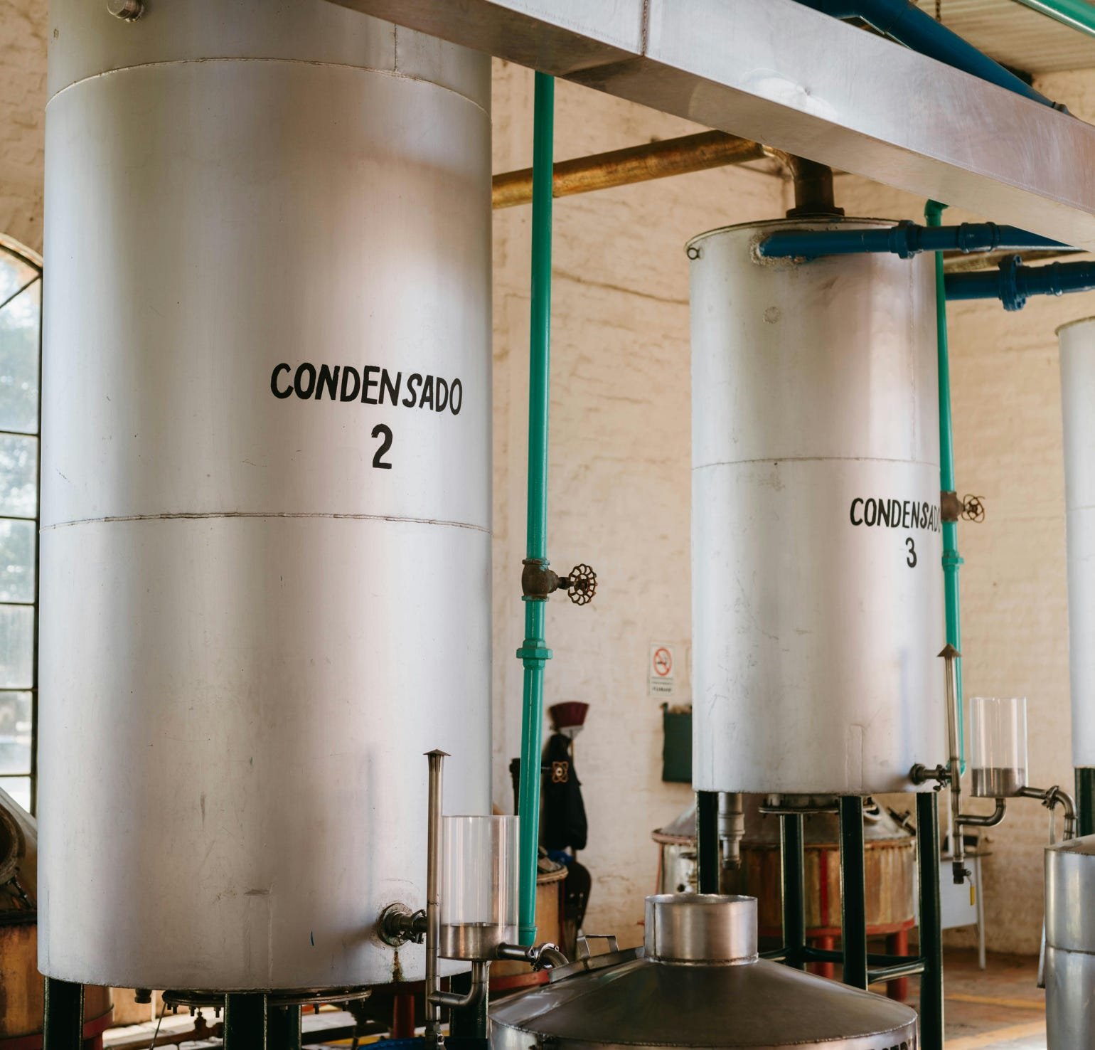 Worker Standing Behind Jute Fibres in Factory